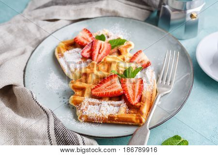 Homemade belgian waffles with strawberries and coffee. Delicious Breakfast.