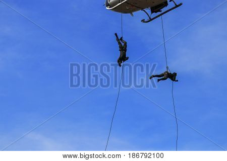silhouette Soldier Jump rope from helicopter in blue sky