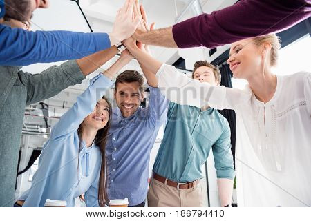 Business Team Giving Highfive Together On Workplace In Office, Young Professional Group Concept