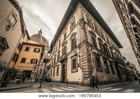 FLORENCE, ITALY. January 08, 2017: Historic center of Florence, Italy. Corner of the Servi and Via dei Pucci. In the background the cathedral of Santa Maria del Fiore.
