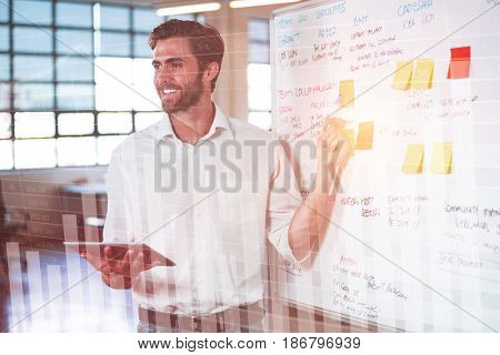 Blue data against smiling businessman explainging strategies on whiteboard