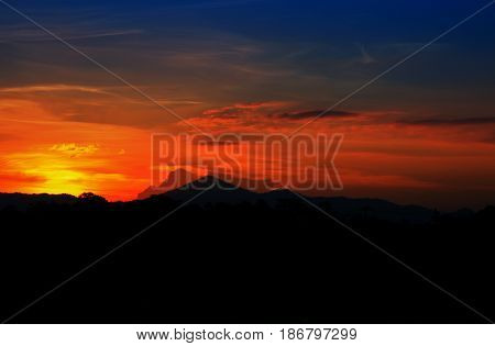 sunset beautiful and silhouette mountain tree woodland colorful landscape in sky twilight time