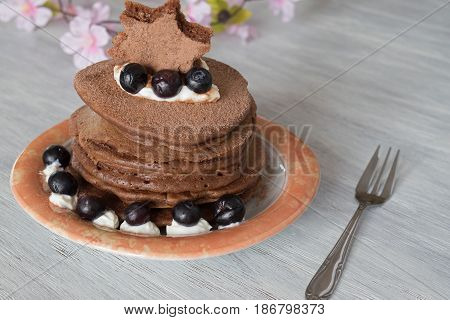 Stack of Delicious Chocolate Pancakes with Blueberries jn table