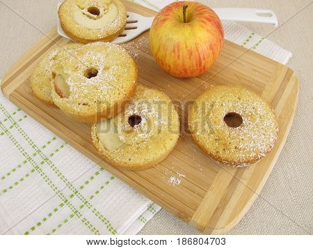 Oven baked apple donuts and a fresh apple