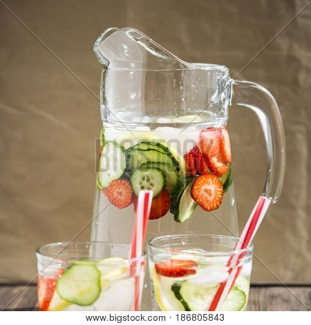 Water with fresh lemon strawberries and cucumber
