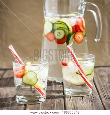 Water with fresh lemon strawberries and cucumber