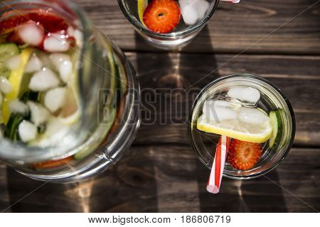 Water withfresh  lemon strawberries and cucumber