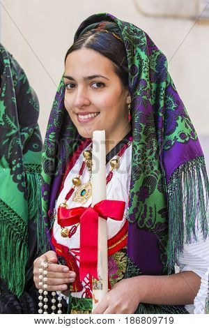 CAGLIARI, ITALY - MAY 1, 2017: 361 Religious procession of Sant'Efisio - portrait of a beautiful smiling girl dressed in traditional Sardinian costume - Sardinia