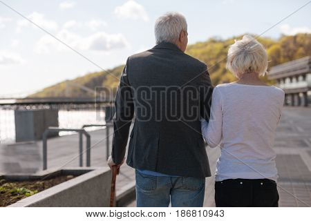 Every day full of happiness. Aged nice cheerful couple keeping together relaxing and enjoying the weekend