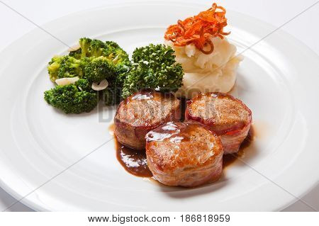 Pork Medallions Wrapped In Bacon, With Potatoes And Broccoli