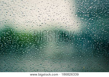 Rain drops on the glass during background