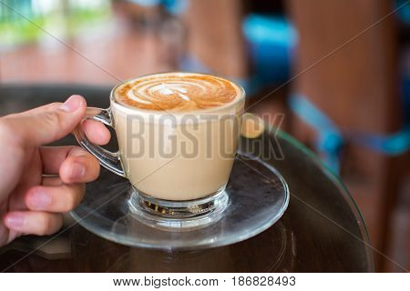 Coffee cup on hand , espresso on hand