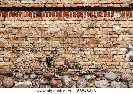 Yellow brick wall background with stone basement