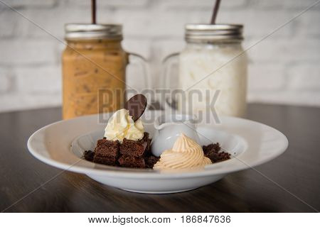 Brownie cake with whipcream background with cold drink coffee and milk shake.