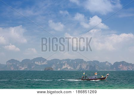 Traditional thai longtail boat in emerald sea at KrabiThailand