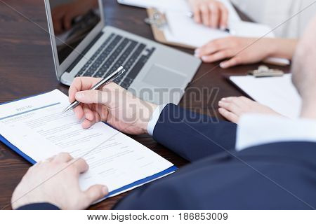Members of cadre checking a resume after recruitment review