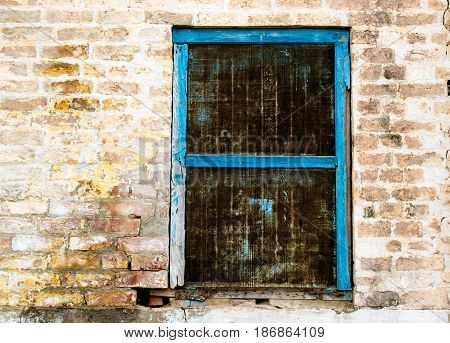 An Old Window Frame Fixed in a Brick Wall
