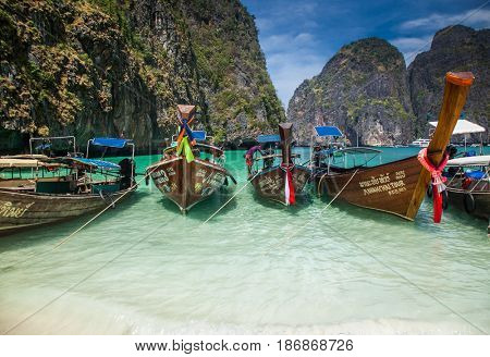 KO PHI PHI LEH, THAILAND, February 1, 2014: Traditional long tail boats on the beach of Maya Bay, Andaman Sea, famous tourist destination in the Ko Phi Phi achipelago