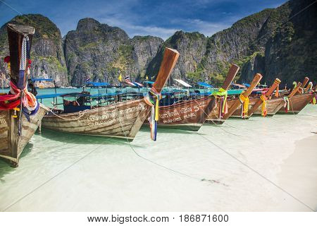 KO PHI PHI LEH, THAILAND, February 1, 2014: Traditional long tail boats on the beach of Maya Bay, Andaman Sea, famous tourist destination in the Ko Phi Phi achipelago