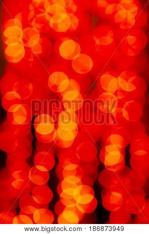Abstract blurred red yellow background. The lights of illuminations or lights in a blur. Bokeh and defocusing