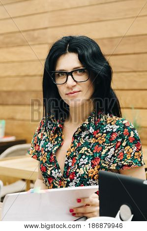 Enterprising young woman preparing a business project in a modern coworking espace