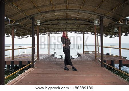 Young girl posing on pier at Lake Siutghiol