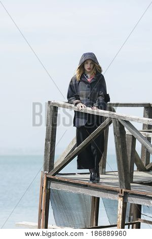 Young girl posing on pier at Lake Siutghiol