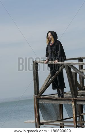 Young girl posing on pier at Lake Siutghiol