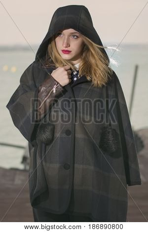 Young girl posing on pier at Lake Siutghiol