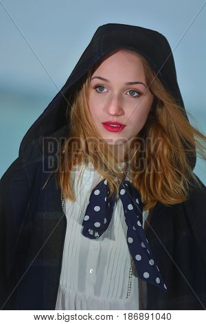 Young girl posing on pier at Lake Siutghiol