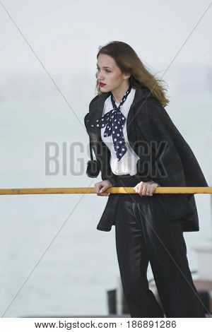 Young girl posing on pier at Lake Siutghiol