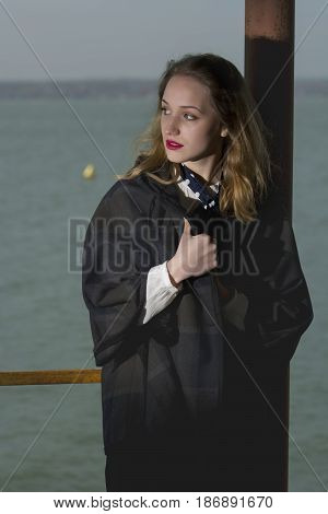 Young girl posing on pier at Lake Siutghiol