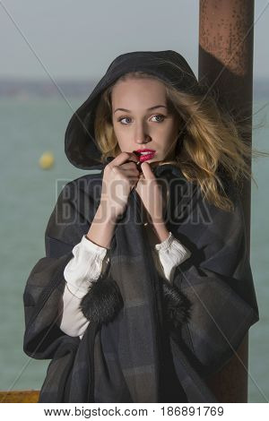 Young girl posing on pier at Lake Siutghiol