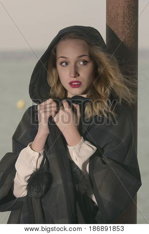 Young girl posing on pier at Lake Siutghiol