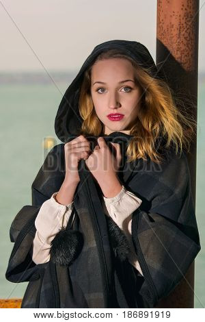 Young girl posing on pier at Lake Siutghiol