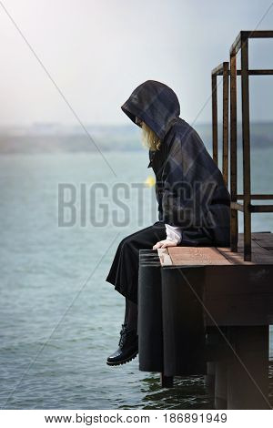 Young girl posing on pier at Lake Siutghiol