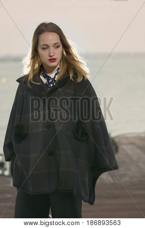 Young girl posing on pier at Lake Siutghiol