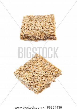 Single piece of a gozinaki confection sweets isolated over the white background, set of two different foreshortenings