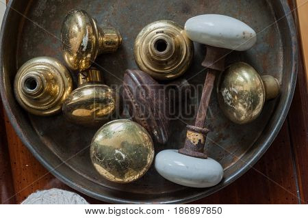 Tin can with rusty and aged door knobs