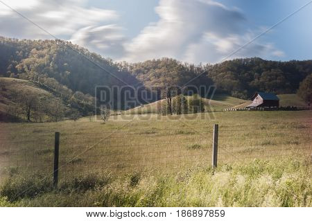 Farm and fence in rural Virginia in late afternoon.