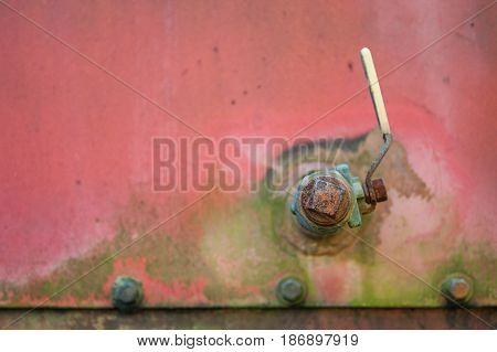 Detail of a valve on the side of an abandoned crane .