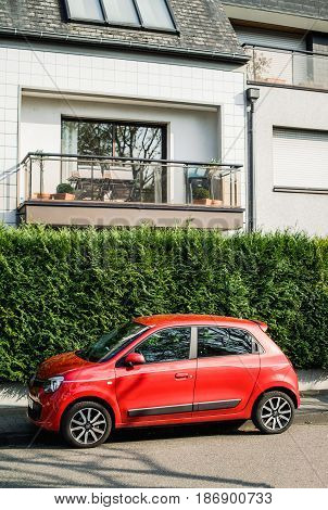 PARIS FRANCE - APR 3 2017: Beautiful red Renault Twingo parked in city. Renault Twingo is a city car manufactured and marketed by the French automaker Renault.