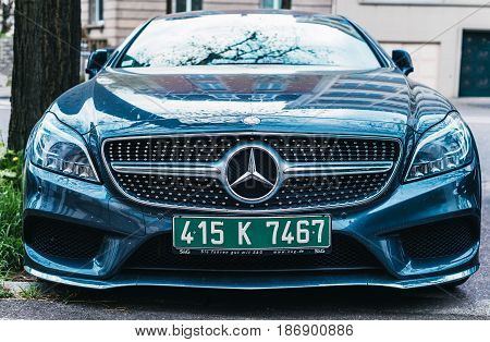 PARIS FRANCE - APR 2 2017: Front view of luxury Mercedes-benz car in majestic blue lava color with green diplomatic plates parked on a street