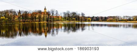 Old castle near the water in the autumn afternoon
