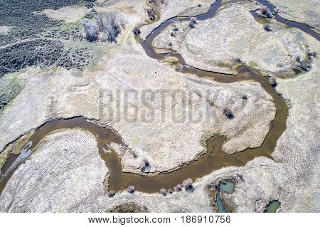 Illinois River meanders through Arapaho National Wildlife Refuge, North Park near Walden, Colorado, early spring aerial view