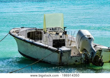 Small, derelict boat on Caribbean beach in BVI