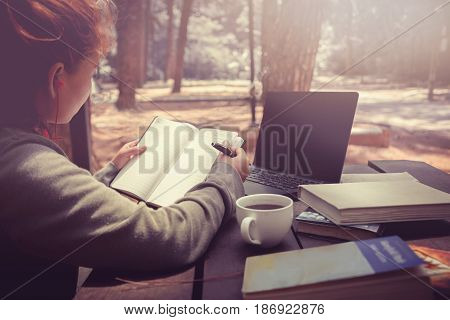 Woman working in a natural garden on vacation.