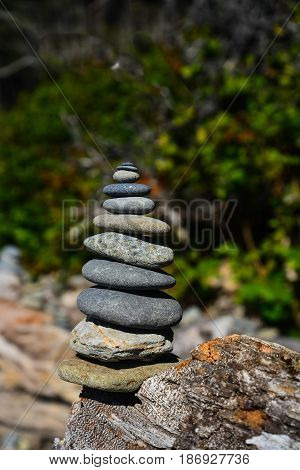 A rock stack of nine flat, round rocks.