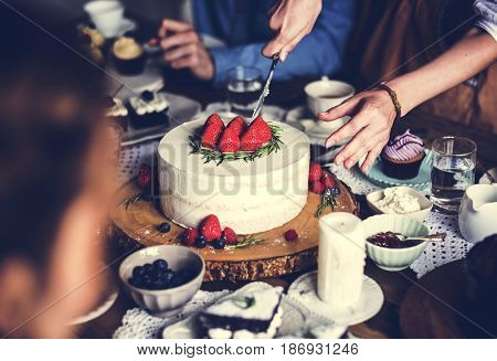 Woman cutting sweet cake to share for the party