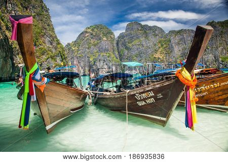KO PHI PHI LEH, THAILAND, February 1, 2014: Traditional long tail boats on the beach of Maya Bay, Andaman Sea, famous tourist destination in the Ko Phi Phi achipelago
